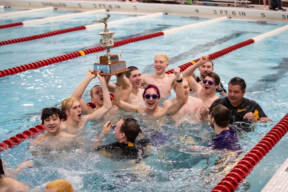Hononegah swimmers and coaches jump in the pool Saturday, Feb. 11, 2023, at Jefferson High School in Rockford to celebrate their record 13th consecutive NIC-10 boys swimming title.