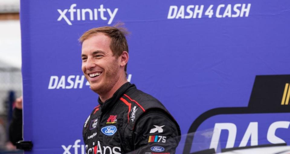 Ryan Sieg smiles in front the Dash 4 Cash banner after winning the bonus after the NASCAR Xfinity Series race at Talladega.