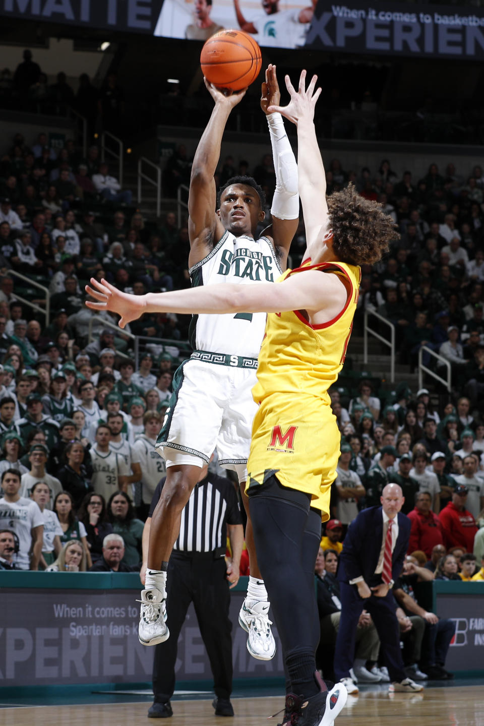Michigan State guard Tyson Walker, left, shoots against Maryland forward Jamie Kaiser Jr., right, during the second half of an NCAA college basketball game, Saturday, Feb. 3, 2024, in East Lansing, Mich. (AP Photo/Al Goldis)