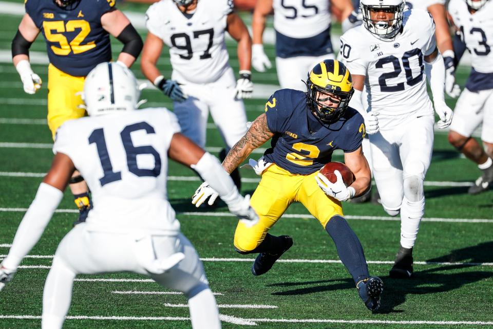 Michigan running back Blake Corum runs against Penn State safety Ji'Ayir Brown during the second half of Michigan's 27-17 loss at Michigan Stadium on Saturday, Nov. 28, 2020.