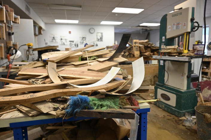 Stockpiles of wood lay destroyed from the floodwaters of Troublesome Creek at the Applachian School of Luthery workshop and museum in Hindman, Ky., Sunday, July 31, 2022. (AP Photo/Timothy D. Easley)