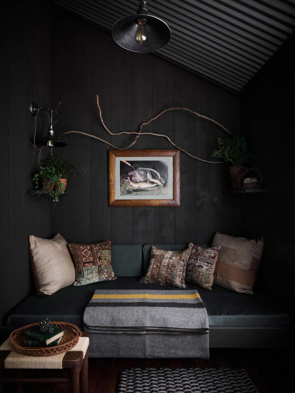 Snyder found pillows made of patchworked rugs on 1stdibs, through J&D Oriental Rugs Co. He used these, along with a blanket from Faribault Woolen Mill Company, to adorn a seating nook on one of the lodge’s two screened porches. (Each bedroom has its own porch.)