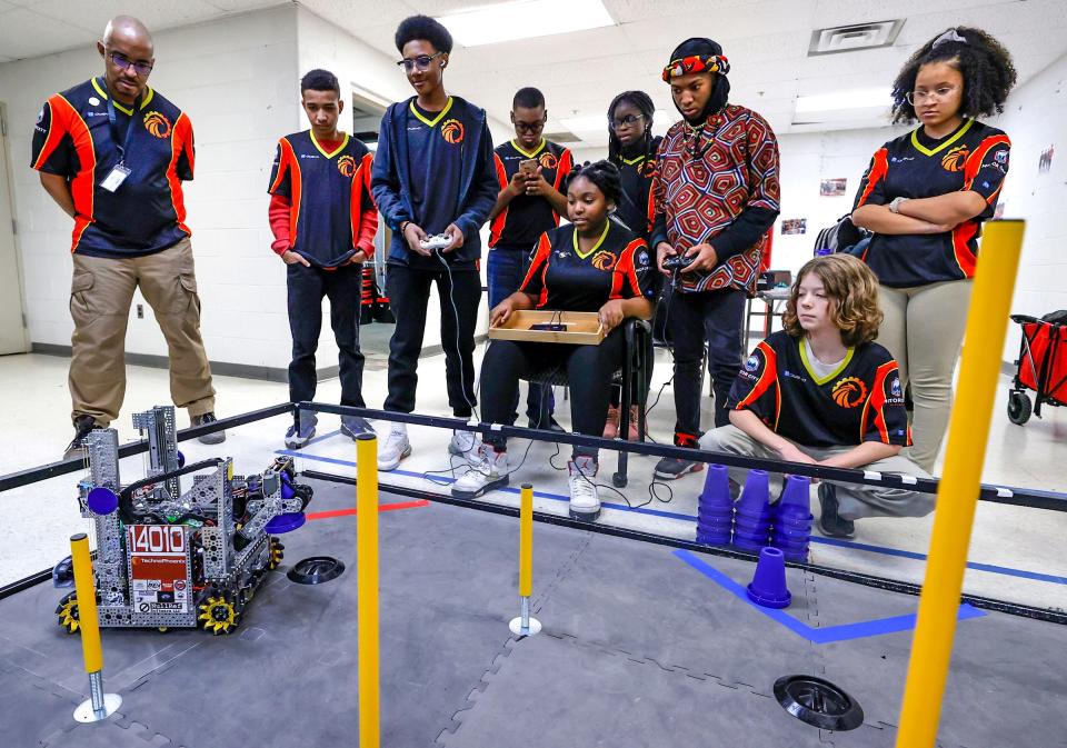 Leon Pryor, the lead coach for the Detroit's Foreign Language Immersion And Cultural Studies School robotics team, far left, watches them practice with their robot for the first time in weeks on Friday, Feb. 10, 2023. The team qualified for the world robotics championship that happens in Houston in April. It is the first Detroit middle school to compete in it.
