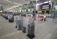 Check in Kiosks are covered in plastic at the domestic check in, at Vancouver International Airport, Tuesday, June 9, 2020. Airlines in Canada and around the world are suffering financially due to the lack of travel and travel bans due to COVID-19. (Jonathan Hayward/The Canadian Press via AP)