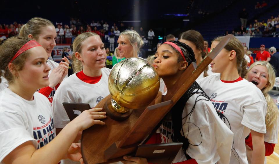 Sacred Heart’s ZaKiyah Johnson kisses the trophy after the Valkyries defeated McCracken County in the Mingua Beef Jerky Girls Sweet 16 final.