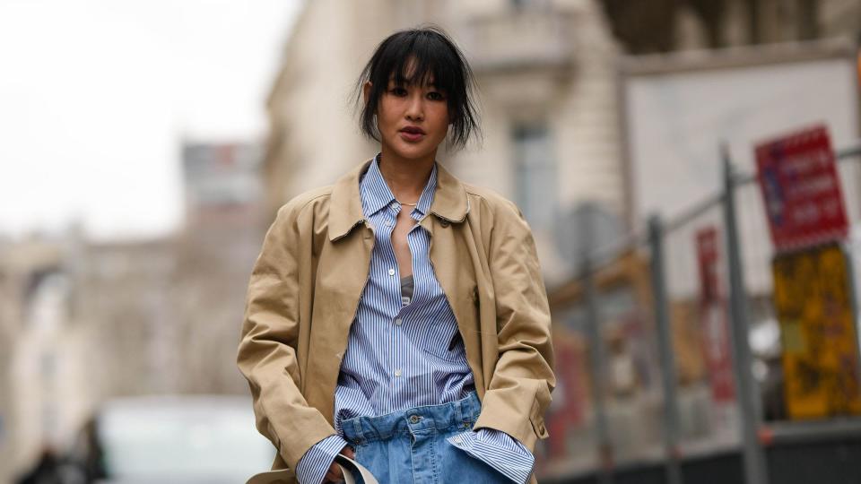 Woman wearing a trench coat with baggy jeans 