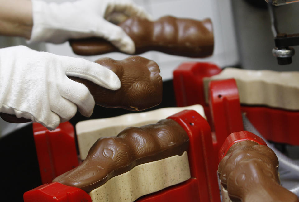 shop price An employee of Hauswirth confectioner puts chocolate easter bunnies into a processing machine at the factory in Kittsee, some 60 km (37 miles) east of Vienna, March 24, 2011. Hauswirth GesmbH processes 20 tons of chocolate per day during peak seasons and exports its products mainly to South Africa and Australia. REUTERS/Lisi Niesner (AUSTRIA - Tags: FOOD BUSINESS)