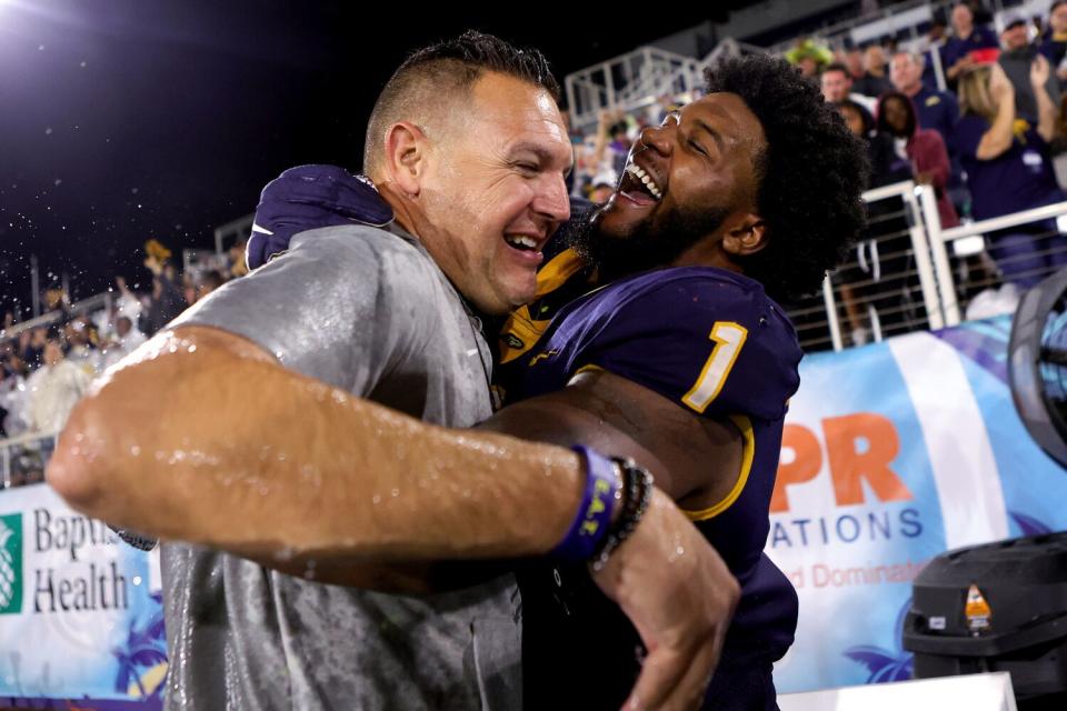 Desjuan Johnson (1) of Toledo celebrates a Boca Raton Bowl victory over Liberty.