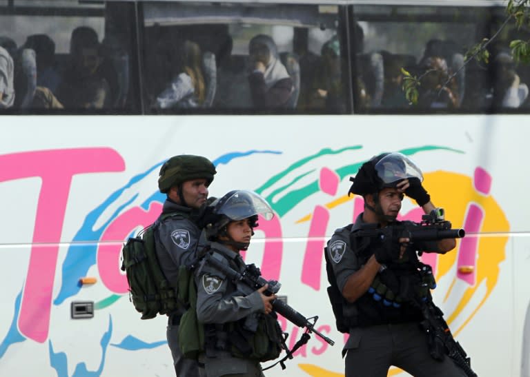 Israeli security forces aim towards Palestinian protesters during clashes on August 1, 2015 near the Jalazon refugee camp in the occupied West Bank