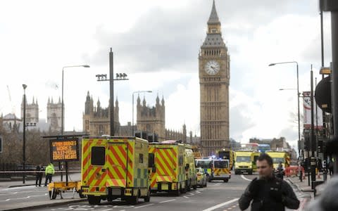 Ambulances stand with other emergency service vehicles on Westminster Bridge, beside the Houses of Parliament and the Elizabeth Tower, commonly referred to as Big Ben, in central London, U.K. on Wednesday, March 22, 2017 - Credit:  Simon Dawson/ Bloomberg