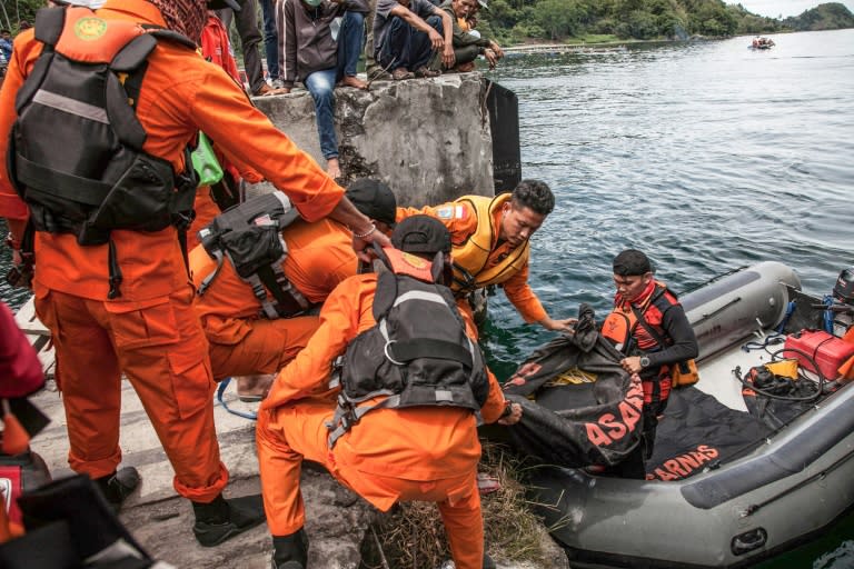 Search teams continue to hunt for bodies in Indonesia's Lake Toba - which is up to 500 metres deep in places - as authorities detained the captain of the overloaded ferry that sank Monday