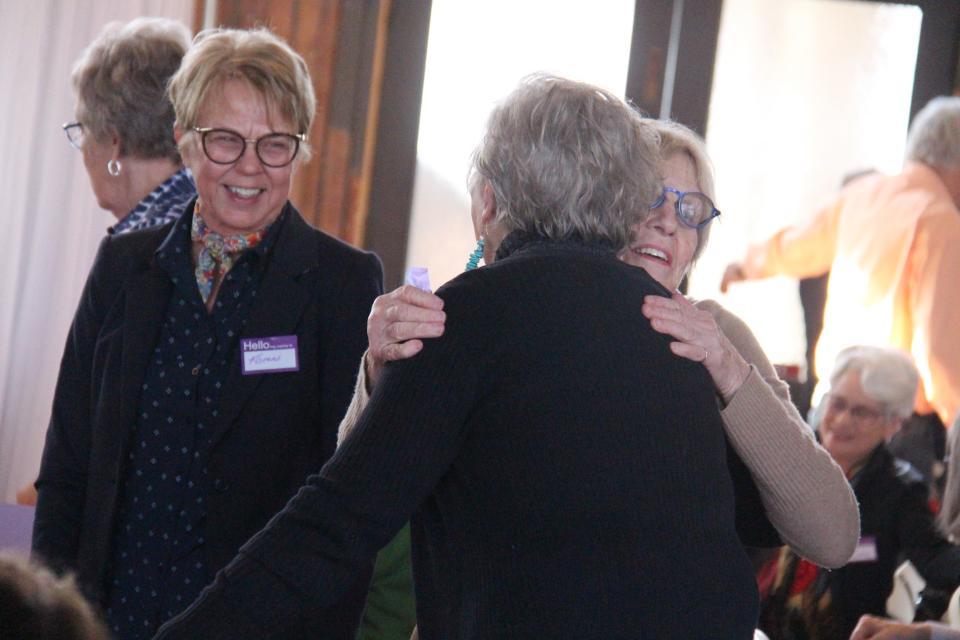 Audience members wish each other a Happy International Women's Day in 2020.