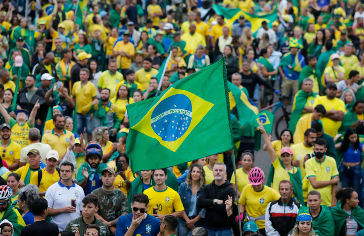 Supporters of Brazilian President Jair Bolsonaro take part in a protest to ask for federal intervention outside the Army headquarters in Brasilia, on November 2, 2022. - Thousands of Bolsonaristas gathered this Wednesday in front of Army commands in the main cities of Brazil to ask for a military intervention in the face of the victory of leftist Lula da Silva at the polls. (Photo by Sergio Lima / AFP)