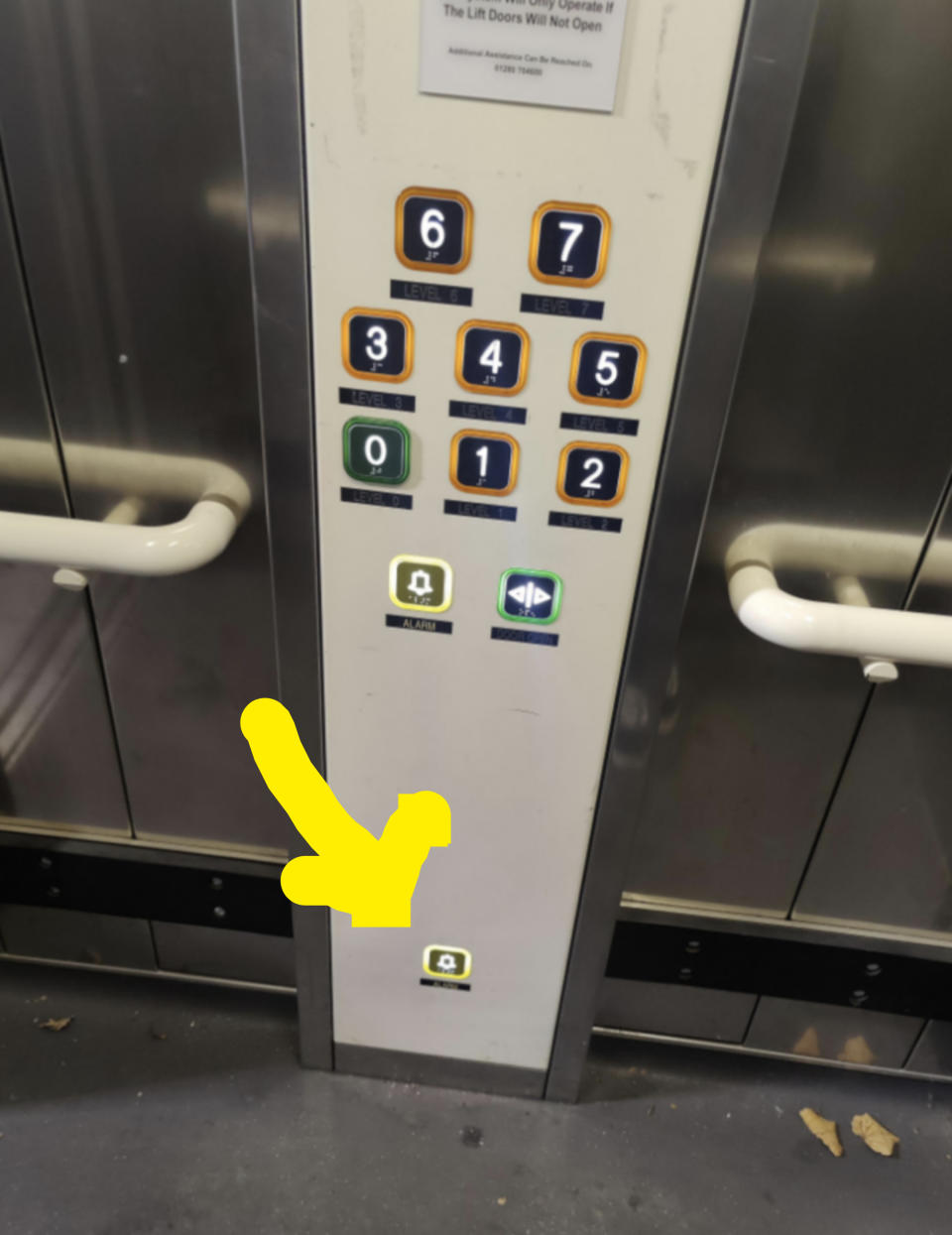 There's one emergency button next to the floor numbers, but a second emergency button located at the very bottom, so it can be pressed from the floor