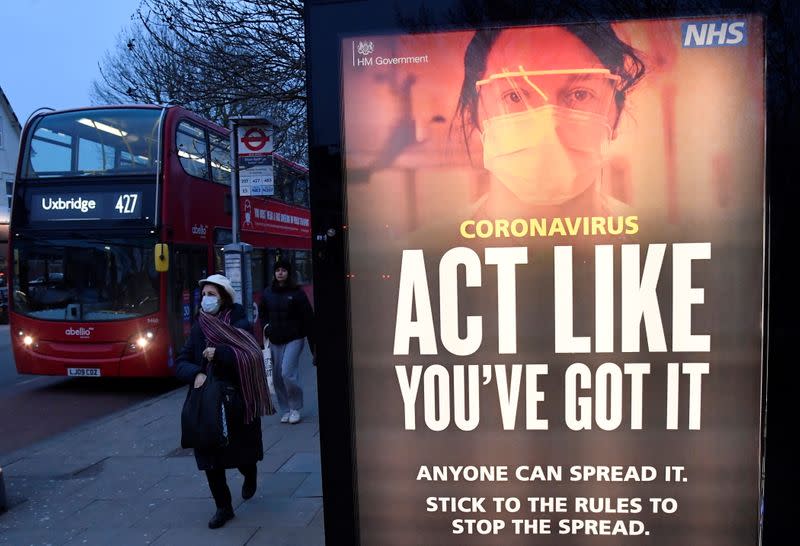 A public health information message is seen at a bus stop in West Ealing , London
