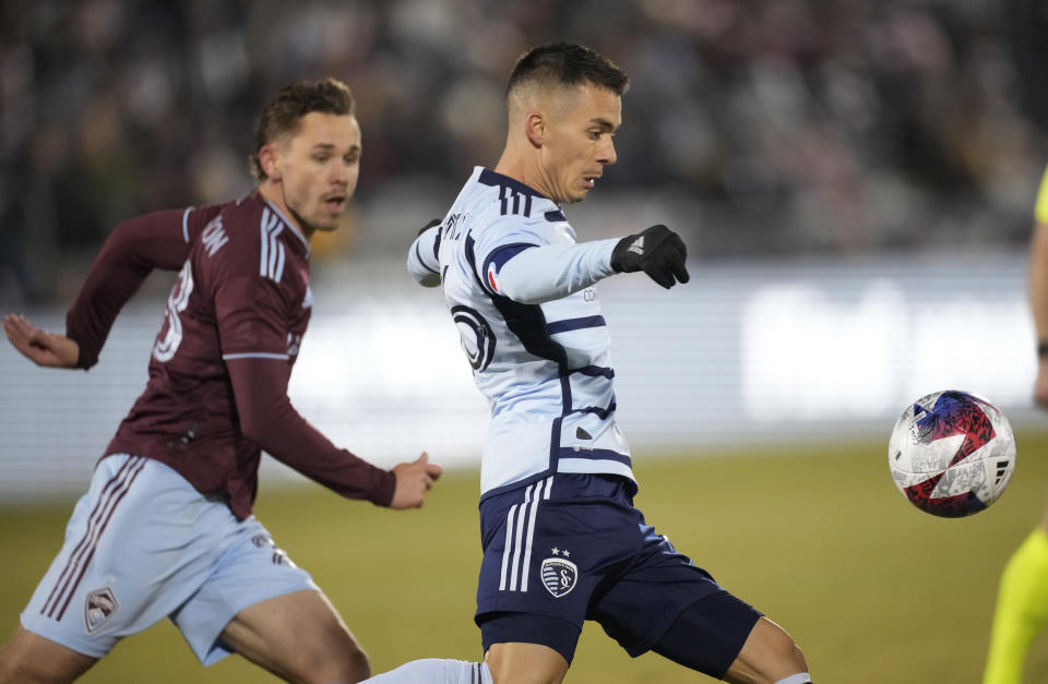 Sporting Kansas City midfielder Erik Thommy, right, looks to clear the ball as Colorado Rapids midfielder Sam Nicholson pursues defends during the first half of an MLS soccer match Saturday, March 4, 2023, in Commerce City, Colo. (AP Photo/David Zalubowski)