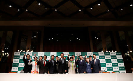 Tokyo Governor Yuriko Koike (4th R), the leader of her new Party of Hope, poses with her party members, including Goshi Hosono, a former environment minister and Masaru Wakasa, a former prosecutor who left the ruling Liberal Democratic Party, during a news conference to announce the party's campaign platform in Tokyo, Japan, September 27, 2017. REUTERS/Issei Kato