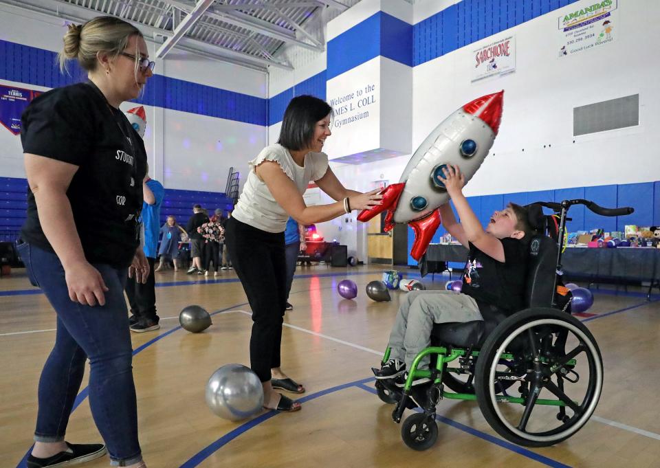 Crestwood Pupil Services Director Sherry Peters, center, plays with John Papick during the “Out of This World” dance party Friday, May 10, 2024, at Ravenna High School.
