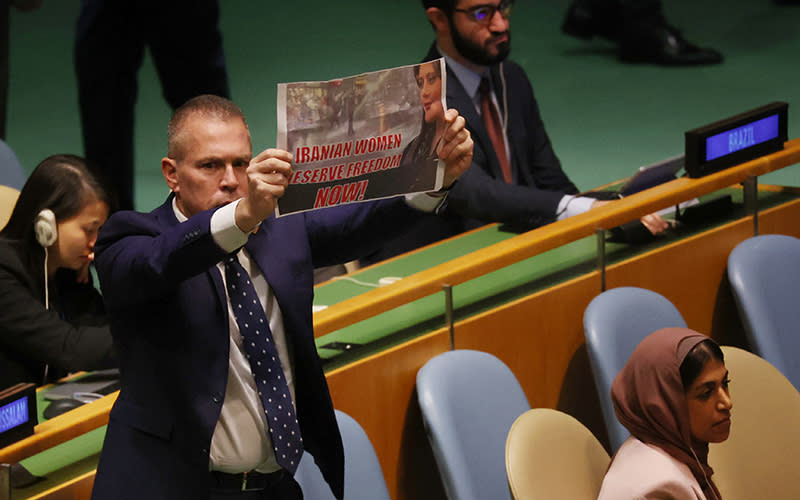 Israel’s Ambassador to the U.N. Gilad Erdan holds up a sign stating 'Iranian Women Deserve Freedom Now.'