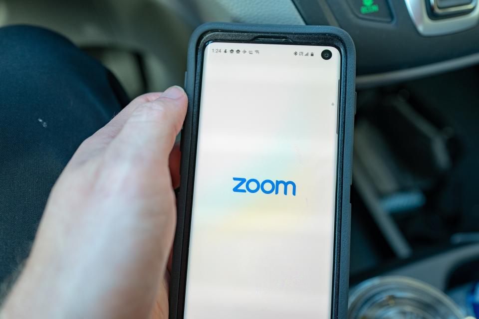 Close-up of hand of a man holding a Samsung Galaxy S10 smartphone with app for teleworking and conference call company Zoom, Walnut Creek, California, March 11, 2020. Amid an outbreak of the COVID-19 coronavirus, many companies have advised employees to work remotely, leading to strong financial performance from telework companies. (Photo by Smith Collection/Gado/Sipa USA)