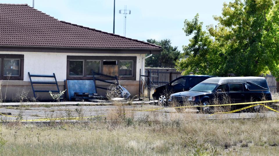 A hearse and debris can be seen at the rear of the Return to Nature Funeral Home in Penrose, Colo. Thursday, Oct. 5, 2023. Authorities said Thursday they were investigating the improper storage of human remains at a southern Colorado funeral home that performs “green” burials without embalming chemicals or metal caskets. (Jerilee Bennett/The Gazette via AP)