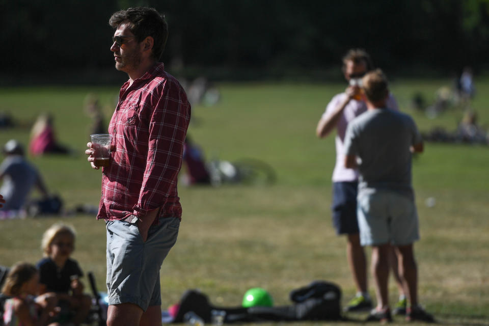 LONDON, ENGLAND - MAY 28: People are seen drinking takeaway pints from a pub on Wandsworth Common on May 28 2020 in London, England. The prime minister announced the general contours of a phased exit from the current lockdown, adopted nearly two months ago in an effort curb the spread of Covid-19.  (Photo by Peter Summers/Getty Images)