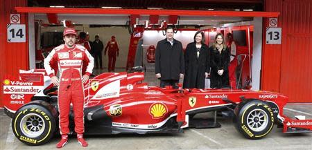 Ferrari's Formula One driver Fernando Alonso of Spain poses in front of the new Ferrari F138 racing car during a training session at Circuit de Catalunya racetrack in Montmelo, near Barcelona, February 19, 2013. REUTERS/Albert Gea