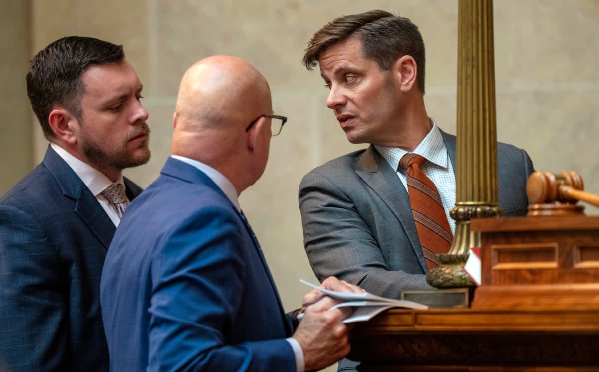 Wisconsin’s Republican Senate President Chris Kapena, right, speaks with lawmakers before a vote to fire Wisconsin Elections Commission administrator Meagan Wolfe on 14 September. (AP)