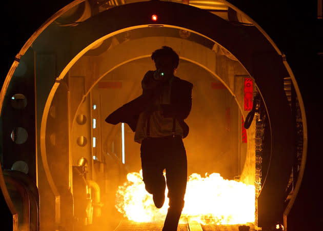 The first image released by the BBC sees the Doctor in some peril, pelting down a fiery corridor.
