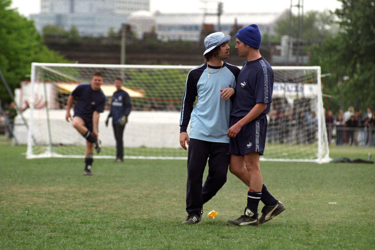 (L-R) Liam Gallagher, of Oasis, and Damon Albarn, of Blur, during the second Music Industry 'Soccer Six' football tournament at Mile End Stadium.   (Photo by David Cheskin - PA Images/PA Images via Getty Images)