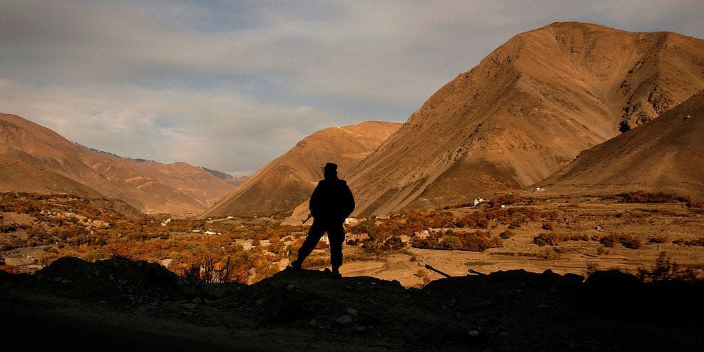 A member of the Afghan army stands guard at a high point overlooking the Panjshir Valley