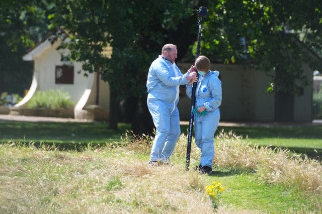 Forensic police officers gathering evidence at Plashet Park