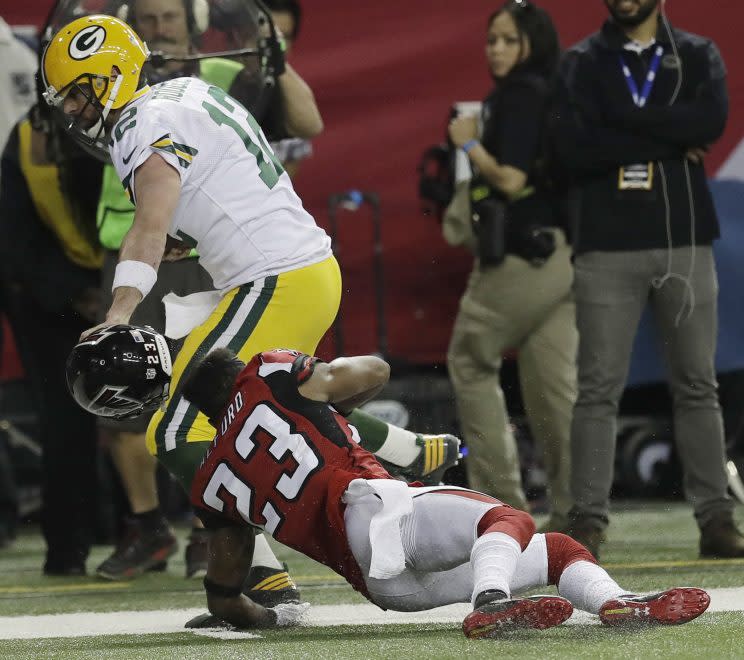 Aaron Rodgers got a 15-yard penalty for grabbing Robert Alford's face mask. (AP)