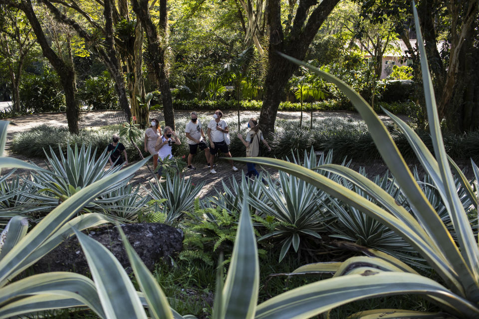 Visitors walk in the garden during a guided tour of Roberto Burle Marx’s former home, which was elected today as a World Heritage Site by the United Nations Educational, Scientific and Cultural Organization, UNESCO, in Rio de Janeiro, Brazil, Tuesday, July 27, 2021. The site features more than 3,500 species of plants native to Rio and is considered a laboratory for botanical and landscape experimentation. (AP Photo/Bruna Prado)