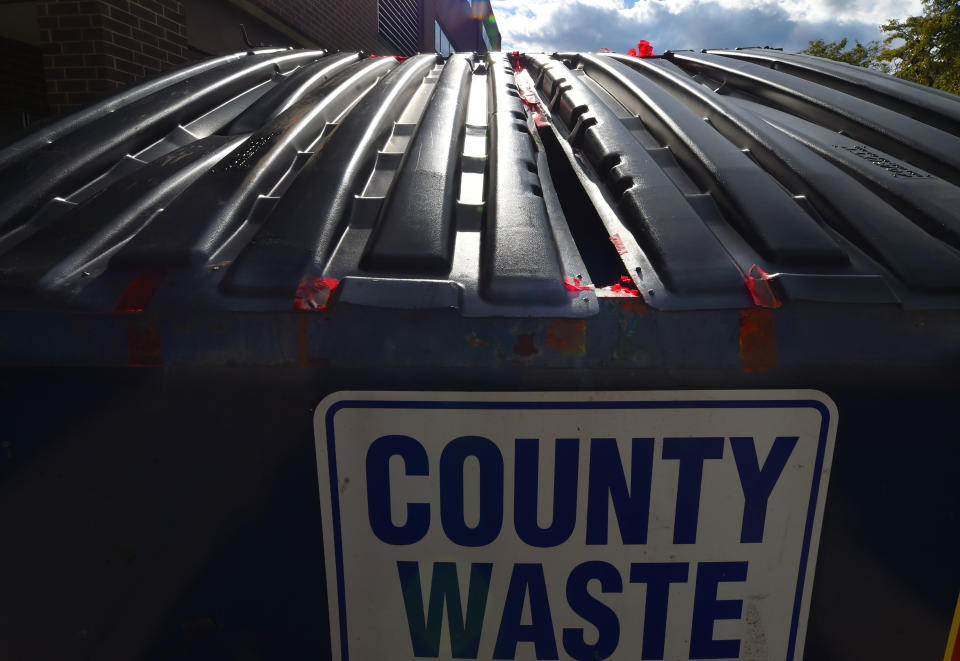 Evidence tape remains on a county waste dumpster outside of the elections board of Luzerne County. A small group of citizens protest outside of Penn Place where the Luzerne County Elections board is located after an investigation into military ballots found in the trash. (Aimee Dilger/SOPA Images/LightRocket via Getty Images)