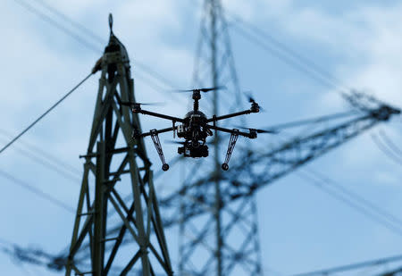 A drone is used to survey high-voltage power lines of electric company Westnetz near Wilnsdorf, Germany, July 11, 2018. REUTERS/Ralph Orlowski