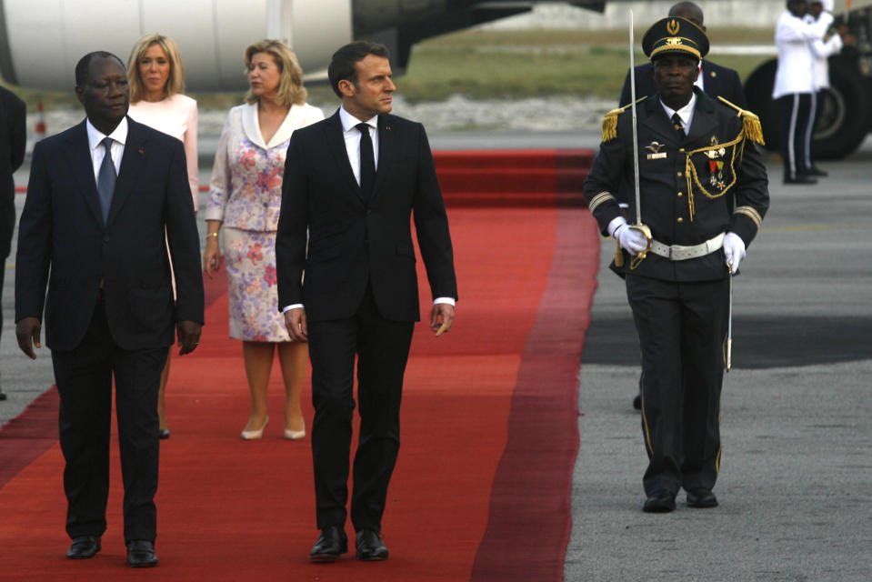 French President Emmanuel Macron is welcomed by President Alassane Ouattara upon arrival in Abidjan, Ivory Coast, Friday Dec. 20, 2019. Macron is in Ivory Coast for a three-day official visit. (AP Photo/Diomande Ble Blonde)