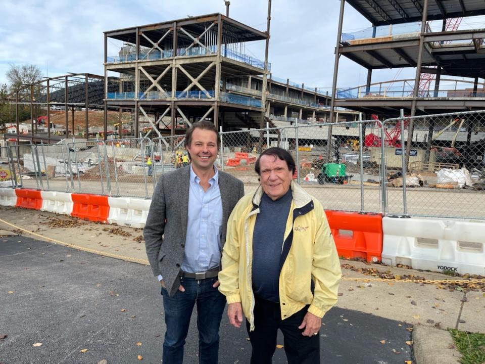 Charles Hand, right, and his family are working with Philip Welker of BNA Development, left, on a $50 million private commercial venture that is to be next-door to F&M Bank Arena, shown in earlier stages of construction behind them.