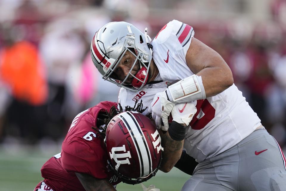 Ohio State tight end Cade Stover (8) is tackled by Indiana's Phillip Dunnam (6) during the second half of an NCAA college football game, Saturday, Sept. 2, 2023, in Bloomington, Ind. (AP Photo/Darron Cummings)