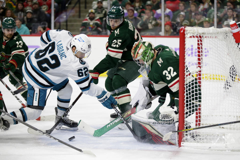 Minnesota Wild goaltender Filip Gustavsson (32) stops a shot by San Jose Sharks right wing Kevin Labanc (62) with Wild defenseman Jonas Brodin (25) and center Sam Steel (13) assisting in the second period of an NHL hockey game Sunday, Nov. 13, 2022, in St. Paul, Minn. (AP Photo/Andy Clayton-King)