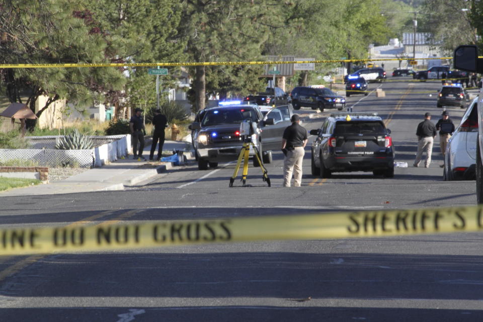 Investigators work along a residential street following a deadly shooting Monday, May 15, 2023, in Farmington, N.M. Authorities said an 18-year-old opened fire in the northwestern New Mexico community, killing multiple people and injuring others, before law enforcement fatally shot the suspect. / Credit: Susan Montoya Bryan / AP