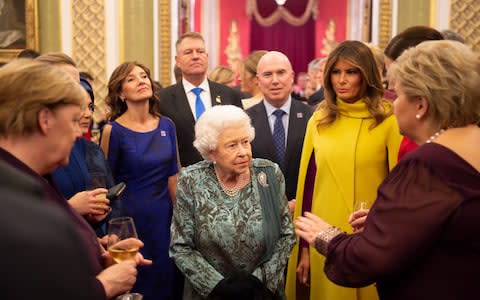 The Queen speaks with Mrs Merkel, Mrs Trump and others during the Nato reception - Credit: Geoff Pugh for The Telegraph&nbsp;