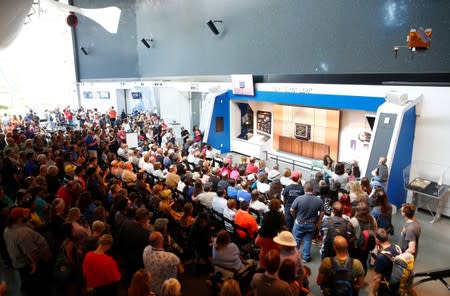 People gather to watch footage at the exact 50 year anniversary of the Apollo 11 moon landing at the Museum of Flight in Seattle