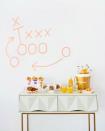 <p>Everyone can appreciate a tailgate brunch, especially one with a well-decorated pastry bar. Inspired by football plays, this blogger designed an X, O and arrow motif on the walls using bright washi tape. </p><p><a href="https://studiodiy.com/pre-gaming-with-pastries-a-tailgating-brunch/" rel="nofollow noopener" target="_blank" data-ylk="slk:Get the tutorial at Studio DIY »;elm:context_link;itc:0;sec:content-canvas" class="link "><em>Get the tutorial at Studio DIY »</em></a> </p>