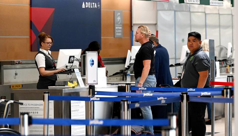 Travelers wait at the Delta ticketing desk at the Sarasota Bradenton International Airport, Sept. 25, 2023.