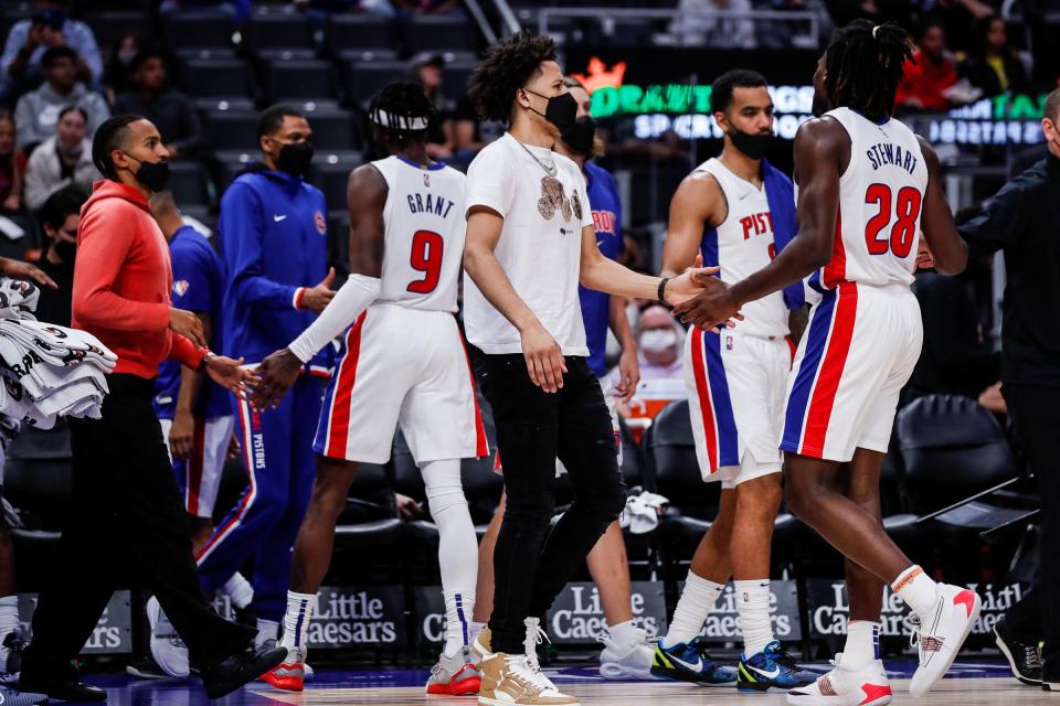 Detroit Pistons guard Cade Cunningham (2) shakes hands with teammates at a timeout against San Antonio Spurs during the first half of a preseason game at Little Caesars Arena in Detroit on Wednesday, Oct. 6, 2021.
