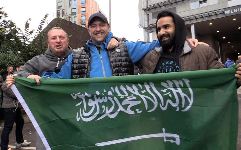 Newcastle fans with Saudi flag - PA