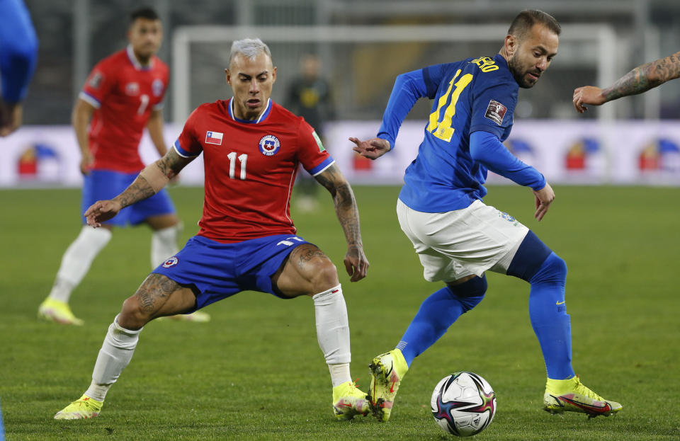 Brazil's Everton Ribeiro, right, and Chile's Eduardo Vargas battle for the ball during a qualifying soccer match for the FIFA World Cup Qatar 2022 at Monumental Stadium in Santiago, Chile, Thursday, Sept. 2, 2021. (Claudio Reyes/Pool via AP)