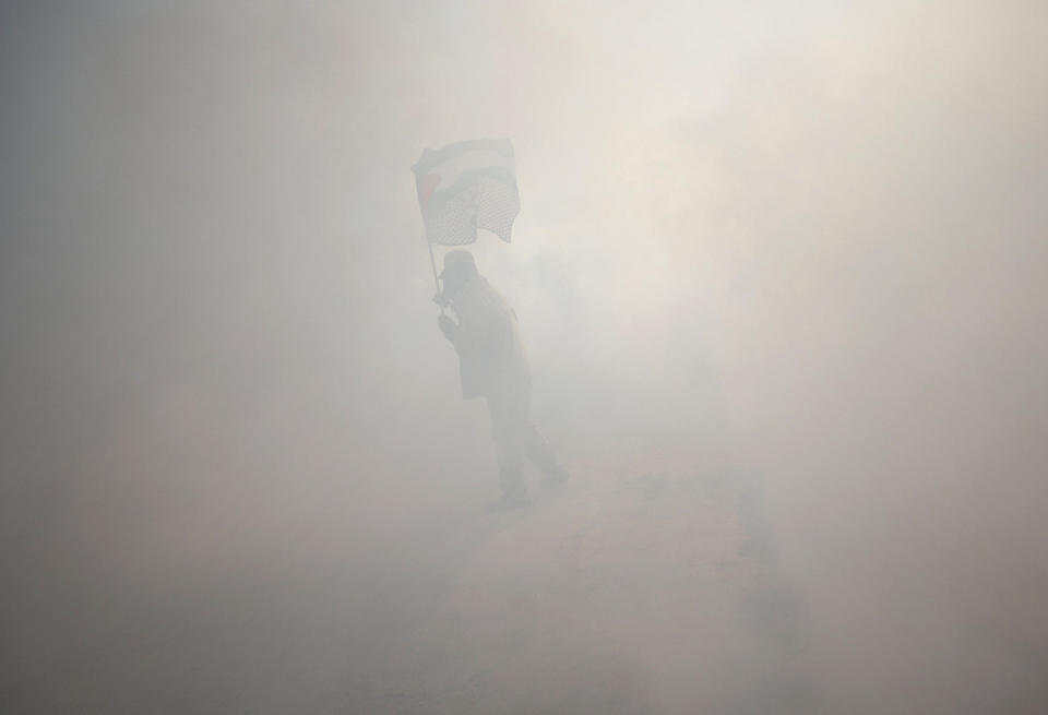 Protester holds a Palestinian flag in the West Bank