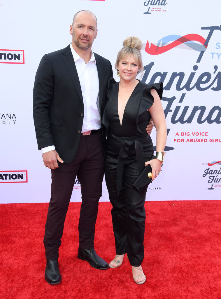 Melissa and her husband, Mark Wilkerson, embracing on the red carpet